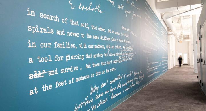 blue wall with cursive and script writing
